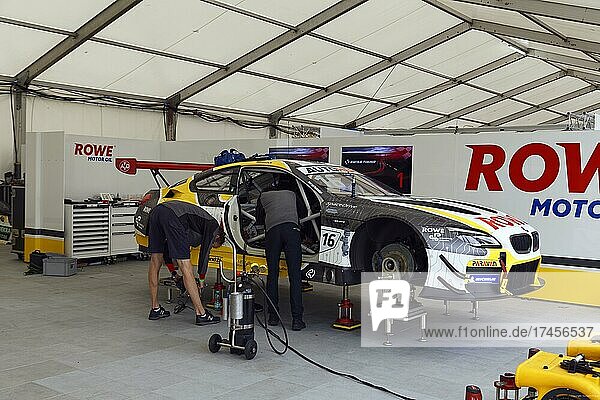 Mechanics work in pit  pit lane on DTM race car  German Torenwagen Masters of racing driver Timo Glock  Rowe Racing BMW M6 GT3  Norisring  city circuit  temporary car race track  Dutzendteich  former Nazi Party Rally Grounds  Nuremberg  Middle Franconia  Franconia  Bavaria  Germany  Europe