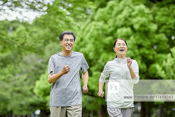 Japanese senior couple training at a city park