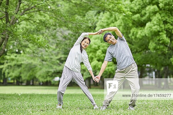 Japanese senior couple training at a city park