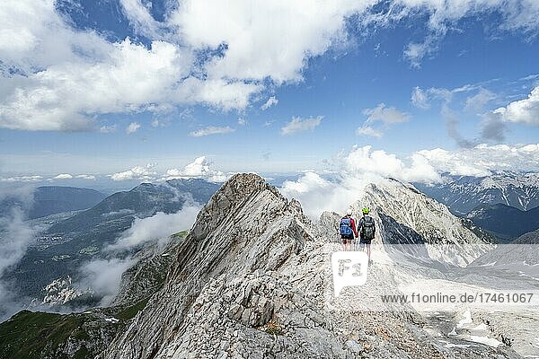 Young couple standing together at the summit after a hike  Wettersteingrad  Patenkirchner Dreitorspitze  Wetterstein Mountains  Garmisch-Partenkirchen  Bavaria  Germany  Europe