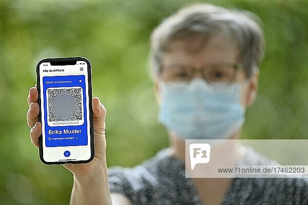 Symbol photo vaccination privileges  elderly woman shows app CovPass on smartphone with digital European vaccination certificate including QR code  Corona crisis  Stuttgart  Baden-Württemberg  Germany  Europe