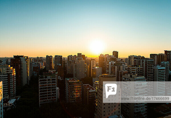 View of cityscape with residential buildings and office buildings at sunset