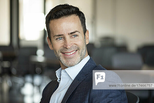 Close-up of smiling businessman in office