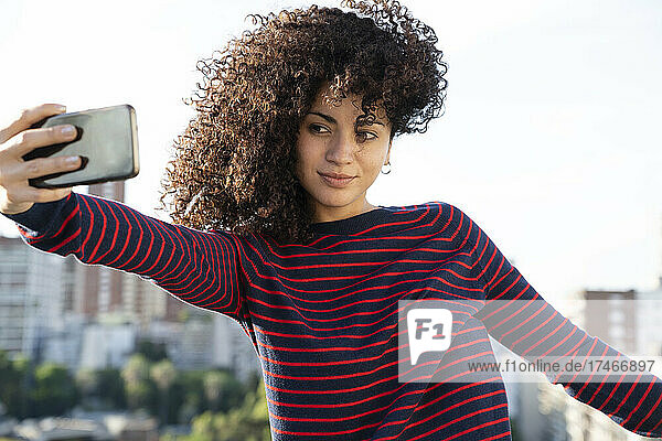 Young woman taking selfie with smart phone