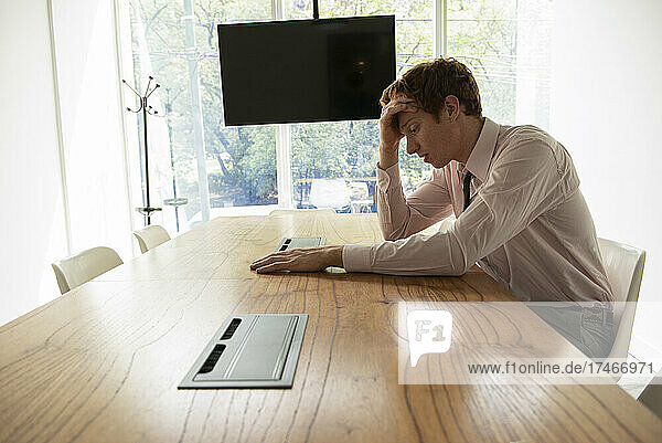 Tired businessman sitting in office