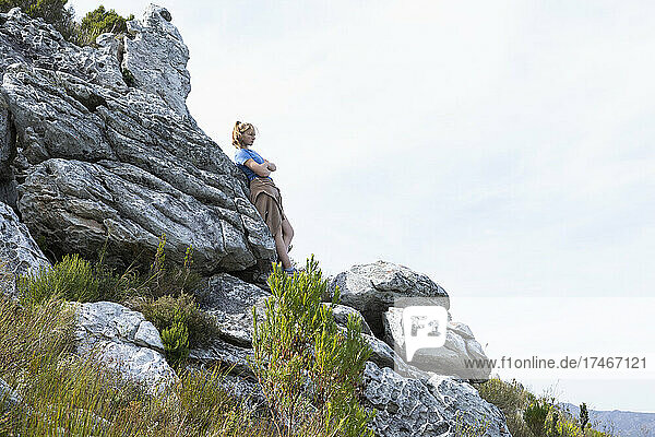 Teenage girl resting and looking out over the landscape
