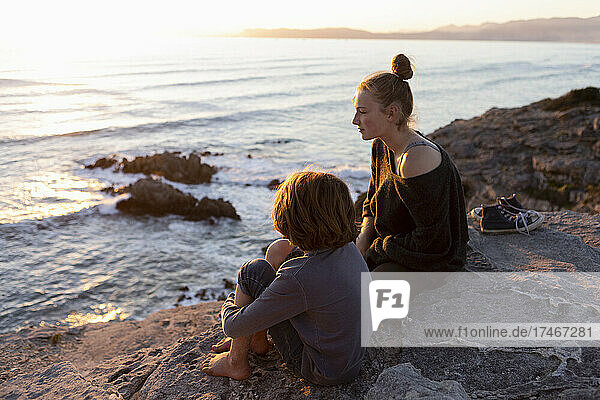 teenage girl and young brother at sunset  Walker Bay Reserve  South Africa