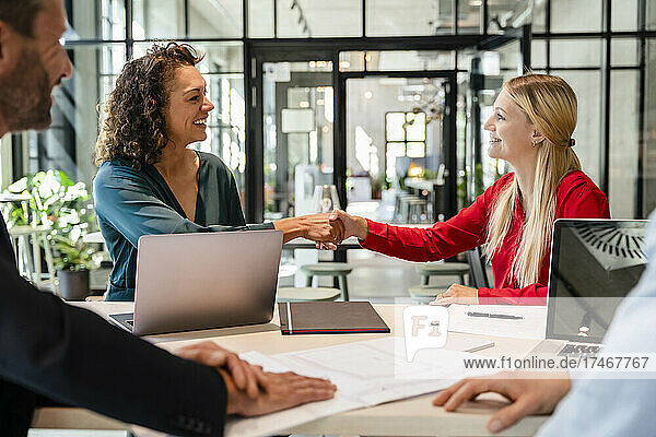 Businesswomen doing handshake in meeting at office