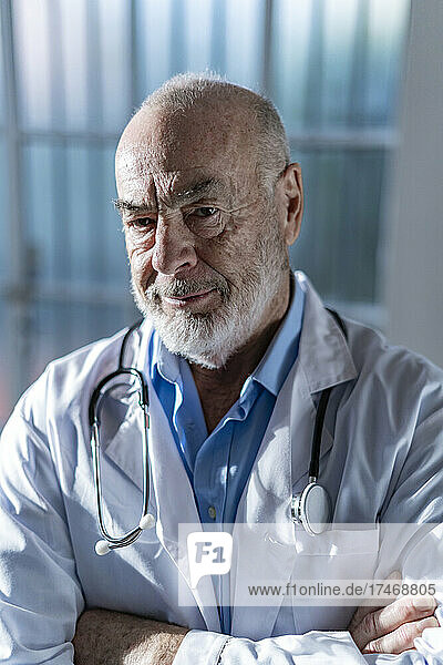Confident senior doctor with arms crossed