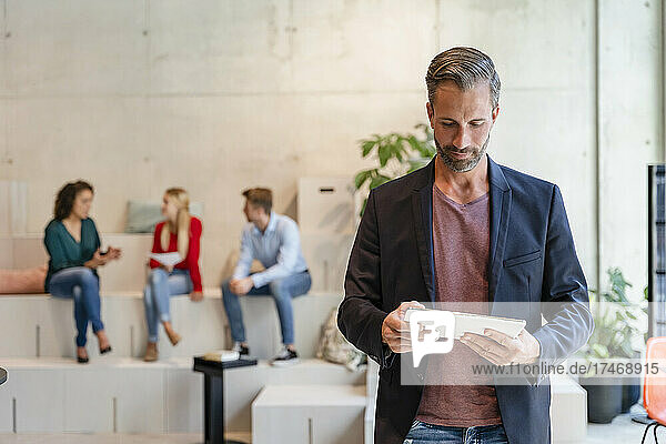Businessman using tablet PC at coworking office