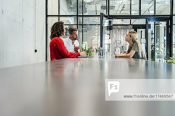 Recruiters having discussion with candidate at conference table