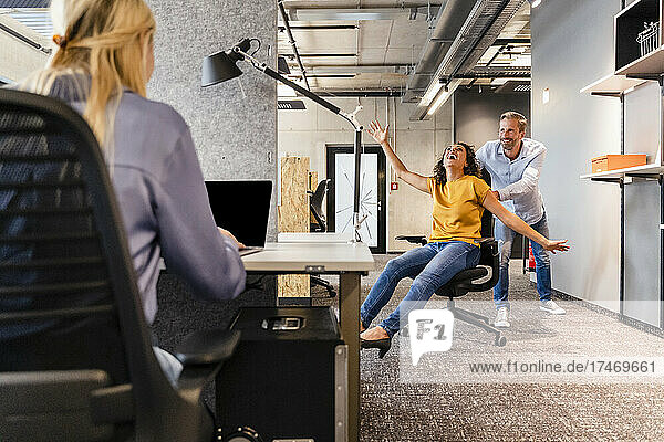 Businesswoman playing with colleague in office