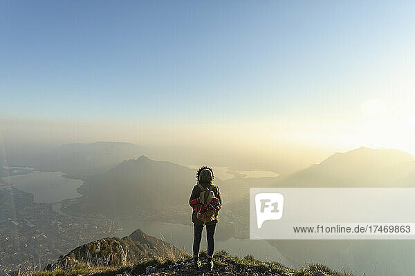 Female hiker looking at landscape from mountain peak  Lecco  Italy
