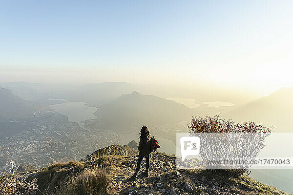 Hiker woman on mountain peakc at sunset  Orobie Alps  Lecco  Italy