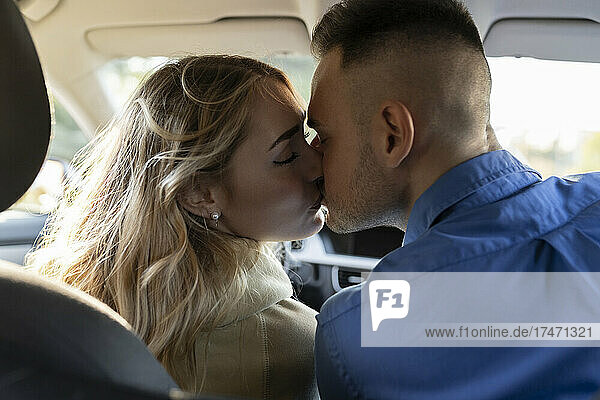 Romantic couple kissing each other in car