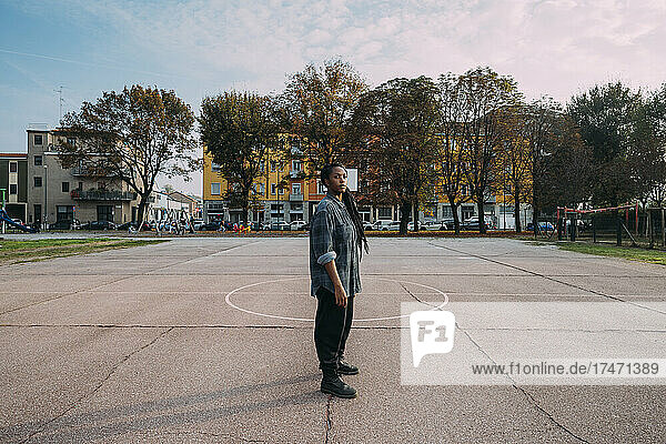 Woman standing at basketball court