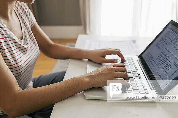 Working woman using laptop at home