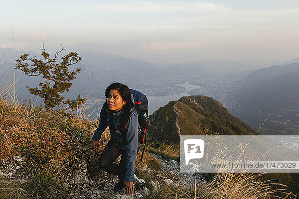 Backpacker climbing on mountain