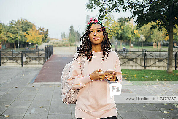 Young black woman enjoying city living outdoor using smartphone - Milan  Lombardy  Italy - browsing  ...