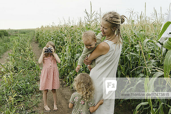 Playful family spending leisure time in corn field