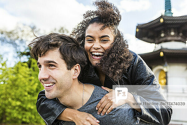 Young man piggybacking female friend