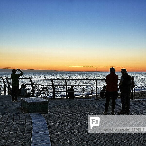 Visitors on Seafront Promenade  Silhouettes after Sunset  Cardigan Bay  Aberystwyth  Ceredigion  Wales  United Kingdom  Europe