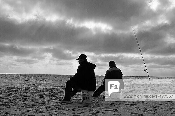 Two anglers sitting on buckets on the beach  Mojacar  Andalucia  Spain  Europe