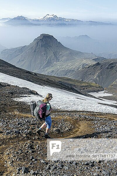 Hiker on the Fimmvörðuháls hiking trail  barren volcanic landscape  Þórsmörk Nature Reserve  Suðurland  Iceland  Europe