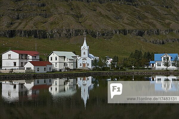 Ausblick über Kirche und Häuser von Seyðisfjörður  Spiegelung im See Fjarðará  Austurland  Ostisland  Island  Europa