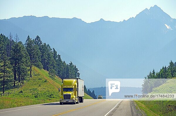 Truck on road  mountain range  Rocky Mountains  Radium Hot Springs  British Columbia  Canada  North America