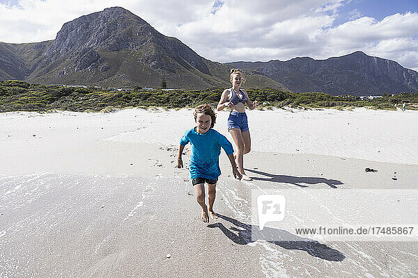 Children playing in surf  Grotto Beach  Hermanus  Western Cape  South Africa.