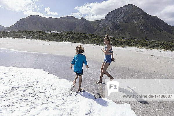 Children playing in surf  Grotto Beach  Hermanus  Western Cape  South Africa.