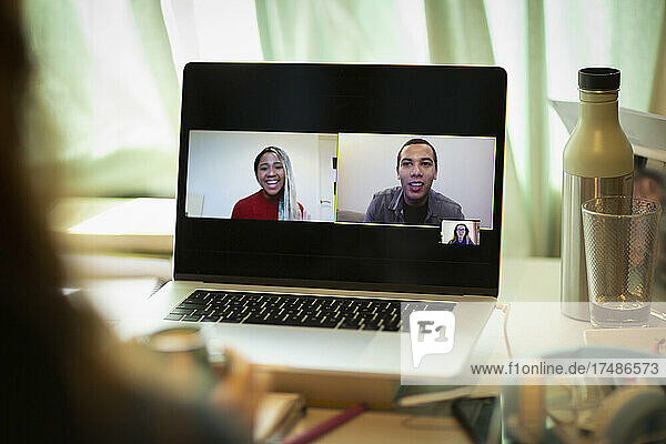 Colleagues video conferencing on laptop screen