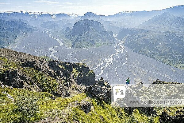 Wanderin genießt ausblick  Panorama  Berge und Gletscherfluss in einem Bergtal  wilde Natur  hinten Gletscher Mýrdalsjökull  Isländisches Hochland  Þórsmörk  Suðurland  Island  Europa