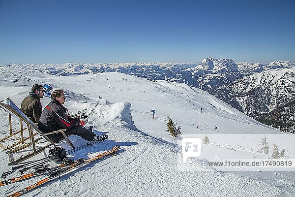 Skiers taking a break in a deck chair  Steinplatte ski area  Waidring  Tyrol