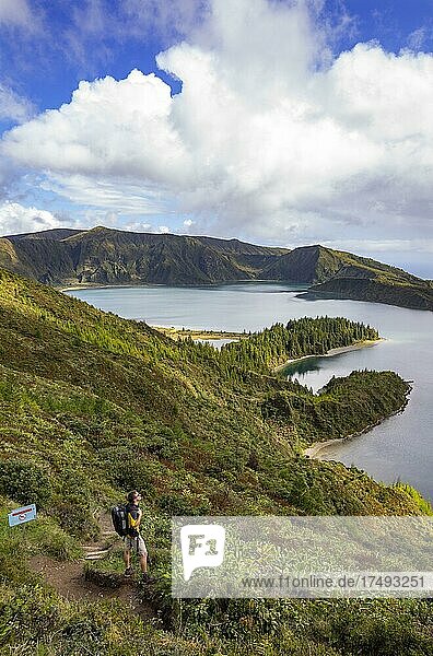 Hiker at the crater rim with view to the crater lake Lagoa do Fogo  Sao Miguel Island  Azores  Portugal  Europe