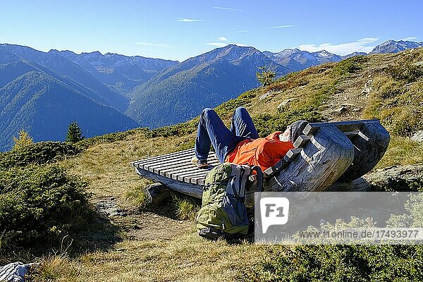 Hiker resting on the Waldburnnenweg  Schwemmalm hiking area  Ulten Valley  South Tyrol  Italy  Europe