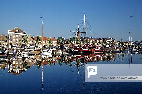 Old ships and houses reflected in the harbour basin  Hellevoetsluis  South Holland  Netherlands