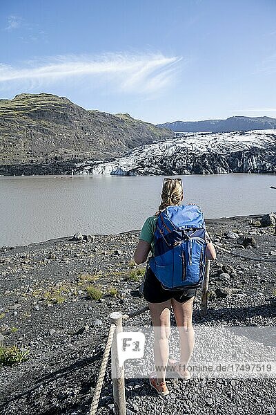 Hiker in front of Sólheimajökull glacier tongue on Mýrdalsjökull glacier  Suðurland  Iceland  Europe