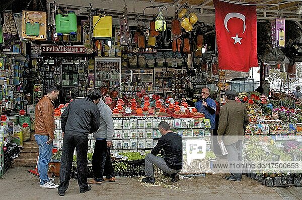 Men in front of plants and spice shop with Turkish flag in Eminönü district  Istanbul  Turkey  Asia