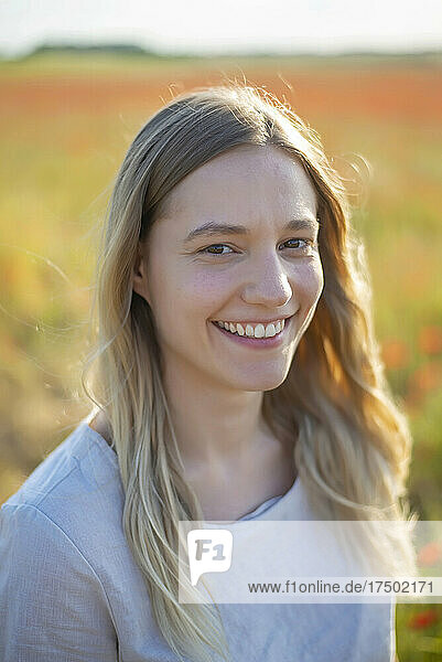 Happy young woman with long blond hair