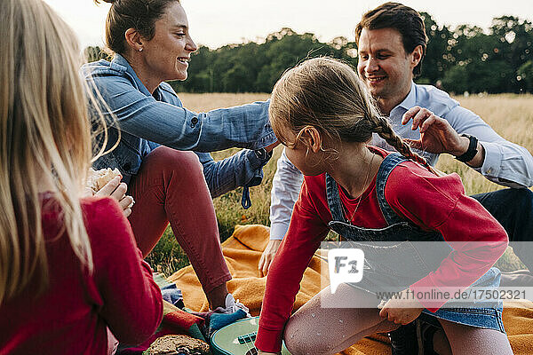 Family enjoying picnic together in park