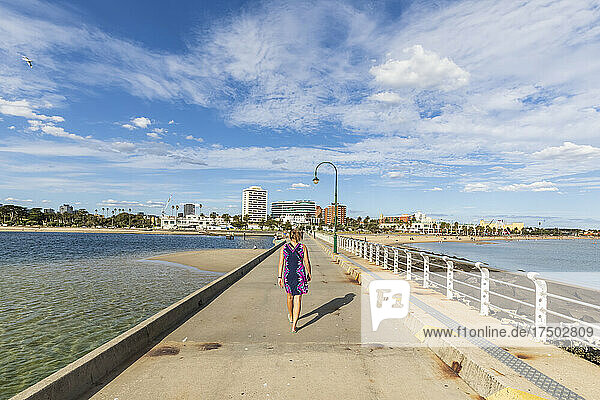Australia  Victoria  Melbourne  Female tourist walking along Saint Kilda Pier