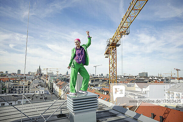 Happy businesswoman dancing on rooftop in city