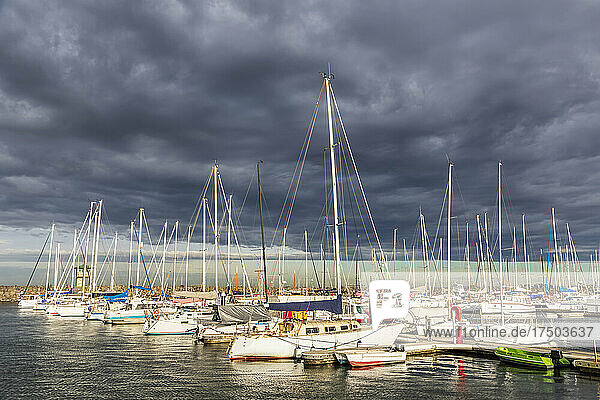 Australia  Victoria  Melbourne  Storm clouds over boats moored in Royal Melbourne Yacht Squadron marina