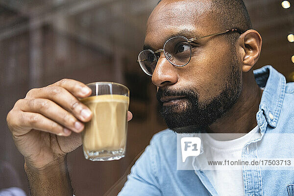 Thoughtful man having coffee in cafe