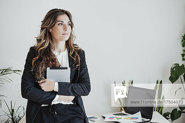 Working woman holding tablet PC at office