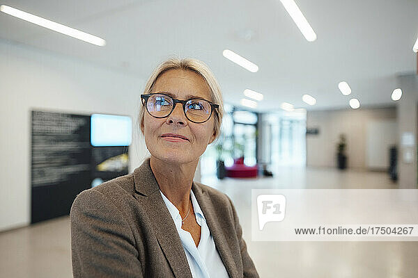Thoughtful businesswoman with eyeglasses in office