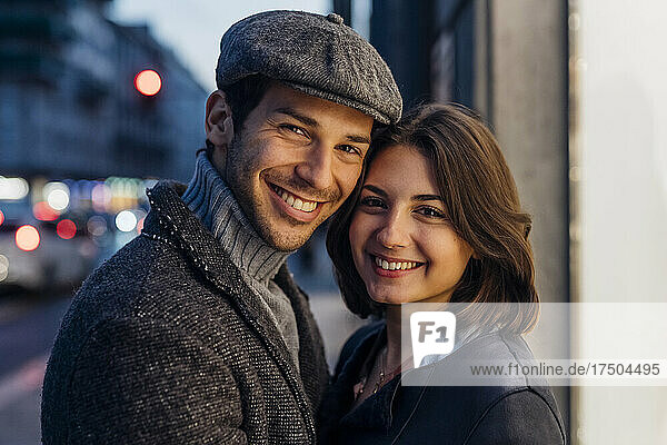 Happy young couple together in city