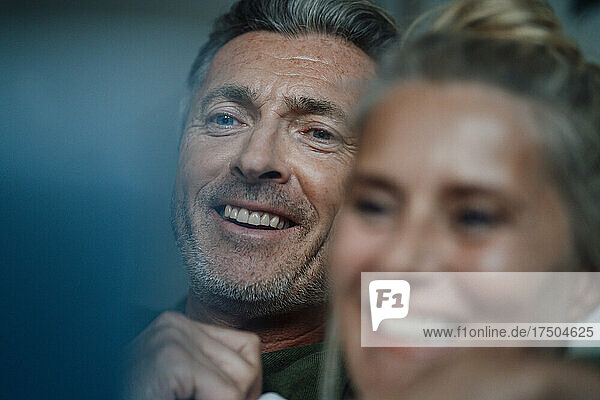 Smiling man with woman at home